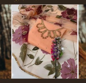 "Peach organza dress with handcrafted neckline and 3D floral embroidered dupatta, ideal for formal and festive occasions."